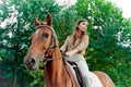 Riding a steed. Woman with horse in countryside. Equestrianism fosters well-being, relaxation. Engage in horse therapy, enjoy