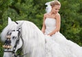 Riding to meet her white knight on the special day. A gorgeous young bride riding a white horse on her wedding day. Royalty Free Stock Photo