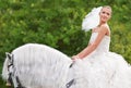 Riding to meet her white knight on the special day. A gorgeous young bride riding a white horse on her wedding day. Royalty Free Stock Photo