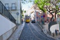 Riding tram in narrow, curvy street, Lisbon