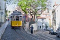 Riding tram in narrow, curvy street, Lisbon