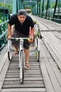 Riding tricycle on Bridge over Pai River at Pai at Mae Hong Son Thailand Royalty Free Stock Photo