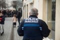 Portrait on back view of french police man walking in the street