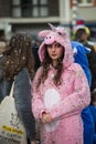 Girl wearing a unicorn costume in the street during the carnival