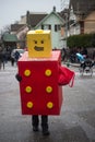 portrait of people with lego costume parading in the street