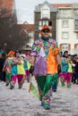 People parading in the street with colorful costume of harlequin
