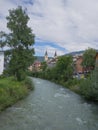 Rienza River Running through the Town of Brunico and the Church in background, Italy