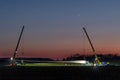 Rieps, Germany, April 21, 2023: Wind turbine blade, transport with special vehicle and alignment with two cranes at night, copy