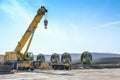 Rieps, Germany, April 22, 2023: Wind turbine blades and a heavy industry crane stored near the construction site of a wind energy Royalty Free Stock Photo