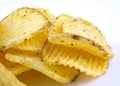 Riffled potato chips with spices on a white background Royalty Free Stock Photo