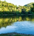 Riffles in the Allegheny river at dusk with shadows on the opposite river side on Althom, Pennsylvania, USA