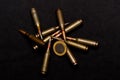 Rifle ammo and one euro coin on black background. Symbolizes the war for money and one of the world`s problems Royalty Free Stock Photo