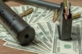Rifle barrel, suppressor and cartridges on dollars. Concept for crime, contract killing, paid assassin, terrorism, war Royalty Free Stock Photo