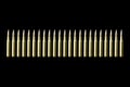 Rifle bullets, long cartridges on black background.