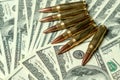 Rifle cartridges on dollars. Concept for crime, contract killing, paid assassin, terrorism, war, global arms trade