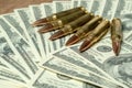 6 rifle cartridges on hundred dollar bills. Concept for crime, contract killing, paid assassin, terrorism, war, global Royalty Free Stock Photo