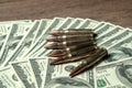 6 rifle cartridges on hundred dollar bills. Concept for crime, contract killing, paid assassin, terrorism, war, global Royalty Free Stock Photo