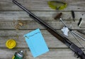 Rifle with cleaning supplies and Firearm Cleaning checklist on rustic wooden background