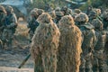 rifle in hands of sniper at camouflage ghillie suit. Army parade soldiers