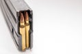 A rifle magazine loaded with 556 bullets on a white background