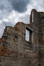 Rift in a brick wall. Close-up. Ruined red brick wall. The wreckage of the wall against the sky. Royalty Free Stock Photo