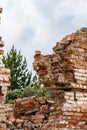 Rift in a brick wall. Close-up. Ruined red brick wall. The wreckage of the wall against the sky. The ruins of the houses