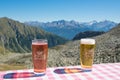 RIFUGIO PORRO, ITALY - SEPTEMBER 5, 2023: Close up of a glass of beer and raspberry juice in the table of Porro alm