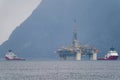 Rig move of Equinor oil platform Njord Alpha with ahts vessels Siem Pearl and Siem Opal inside the Norwegian fjord. Royalty Free Stock Photo
