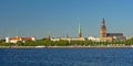 Riga castle, cathedral and St. Petrus church view from across the river. Latvia