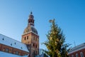 Riga Dome Cathedral at old town square in Riga, Latvia. Close up view on tower and Christmas tree. Sunny winter day Royalty Free Stock Photo