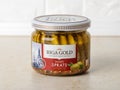 Riga gold smoked sprats in olive oil in a glass jar on a kithen table. Traditional baltic fish ingredient for appetizers and