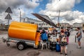 RIGA, LATIVA - AUGUST 25, 2023: Kvas seller in the streets of riga, selling kvass from a tank to clients. Kvas is a fermented Royalty Free Stock Photo