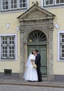 Fiance and bride are kissing at the entrance of building