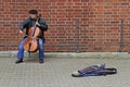 Street musician is playing cello outdoor in Riga, Latvia Royalty Free Stock Photo