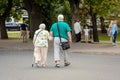 RIGA, LATVIA - AUGUST 18, 2018: A couple of elderly people walk in the arms of their hands. View from back.