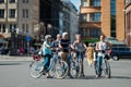 RIGA, LATVIA - AUGUST 14, 2015: Group of tourists on bicycles in the streets. Guided tour led by a guide Royalty Free Stock Photo