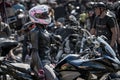 24-04-2019 Riga, Latvia. Biker girl in a leather jacket and helmet on a motorcycle