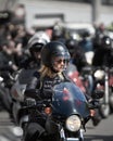 24-04-2019 Riga, Latvia. Biker girl in a leather jacket and helmet on a motorcycle