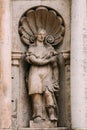 Riga Latvia. Close Ancient Statue Of Woman With Kissing Doves In Hand On The Facade Of St. Peter Church, Royalty Free Stock Photo