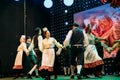 Christmas Performance. Actors Dressed In Traditional Folk Costume Dancing Folk Dances During Christmas Holidays. Winter