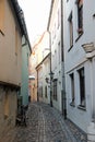 Riga / Latvia - 01 December 2019: Narrow medieval street in old city of Riga, Latvia Royalty Free Stock Photo