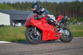 12-06-2020 Riga, LAtvia. Fast motorbike racing on the race track at high speed. Composite image with heavy image editing