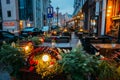 Riga, Latvia. Free Tables Of A Street Cafe With Decorative Lighting At Evening Or Night Illumination In Old Town In