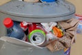 Garbage bins full on Rigas Town Street.A pile of abandoned garbage on the street, including food waste, cans of cola, beverage, Royalty Free Stock Photo