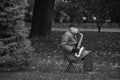 RIGA, LATVIA - JULY, 2017: Black and white image of old man plaing saxophone in a park