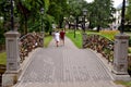RIGA / LATVIA - July 27, 2013: Couple walk in the city park near the bridge with many padlocks as a signs of love