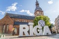 Riga, Latvia- July 7, 2023: Dome Square with Riga Cathedral in old town with Riga sign in front