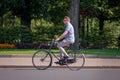 RIGA, LATVIA - JULY 18, 2018: A man with a bicycle runs along the street.