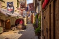 Riga, Latvia - July, 2013. Medieval street and fragment of outdoors cafe in the old city of Riga Royalty Free Stock Photo