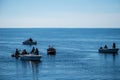 Riga, Latvia - July 10, 2023: people fishing from boats and the pier Daugavgriva breakwater or pier in the Gulf of Riga of the